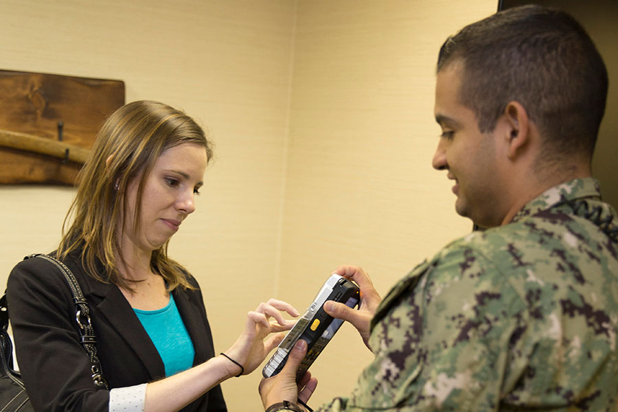 Chief Information Security Officer and sailor inspect device